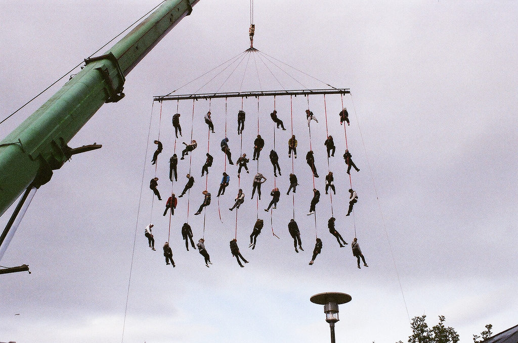 Crane with people dangling from it