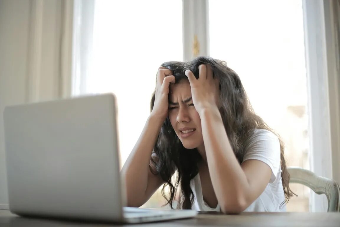 Frustrated woman looking at laptop