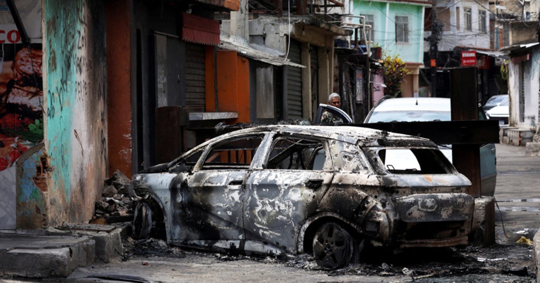 Burnt-out car in Rio favela